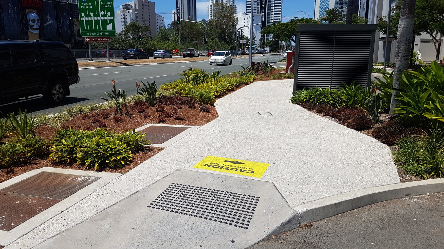 A Pacific Fair softscape project — paved walkway and freshly mulched garden bed